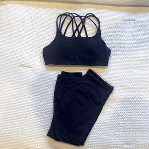 ATHLETA Navy blue sports bra and capri leggings.
